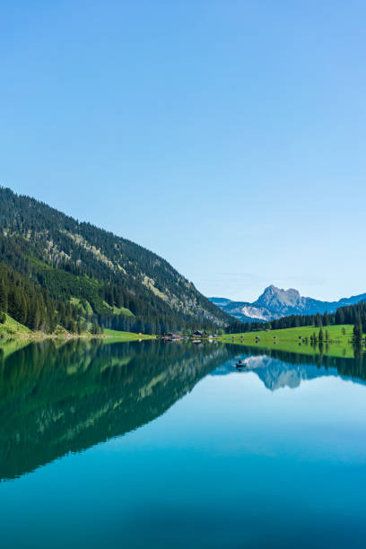 istock Fisherman in a boat on a mountain lake 1176848345
