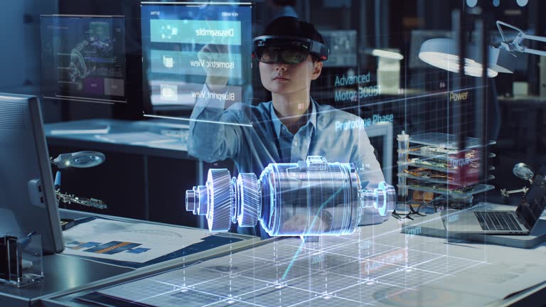 Industrial Factory Chief Engineer Wearing AR Headset Designs a Prototype of an Electric Motor on the Holographic Smart Blueprint. Futuristic Virtual Design of Mixed Technology Application.