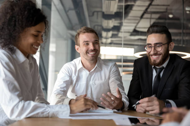 istock Smiling diverse colleagues having fun at business briefing in office 1176848636