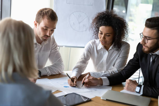 istock Diverse employees discussing business strategy, working on project together 1176848639