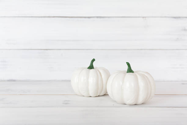 istock White pumpkin on white wood table with copy space. 1176851585