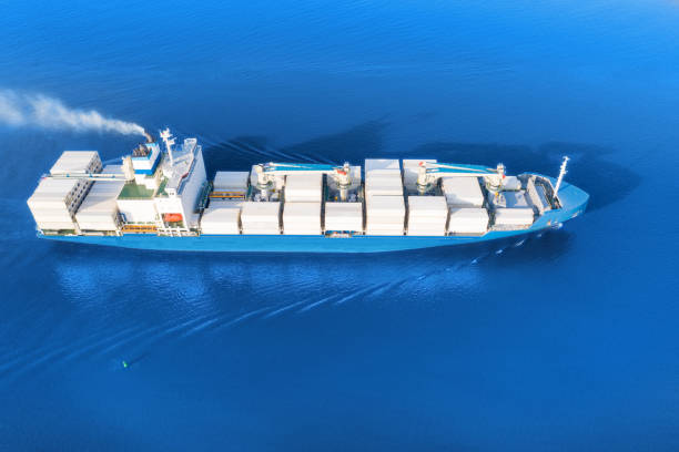 istock Large container ship sailing blue sea. Aerial view 1176851707