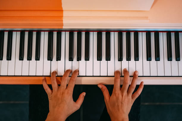 istock Woman Hands Playing the Piano 1176853045