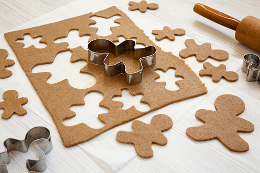 Gingerbread cookies with different figures on a wooden table. Christmas dessert.