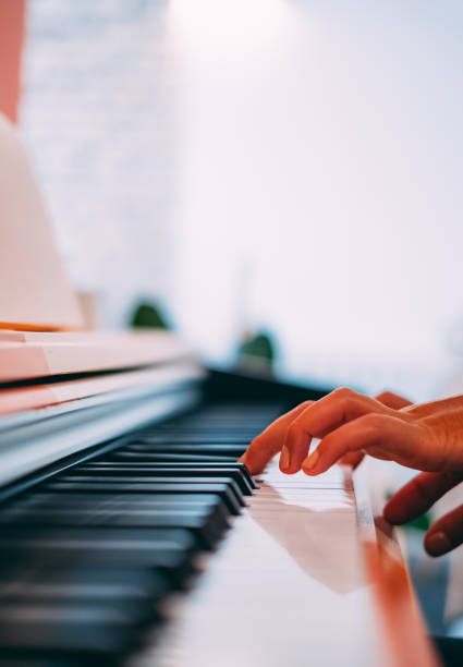 istock Woman Hands Playing the Piano 1176853118