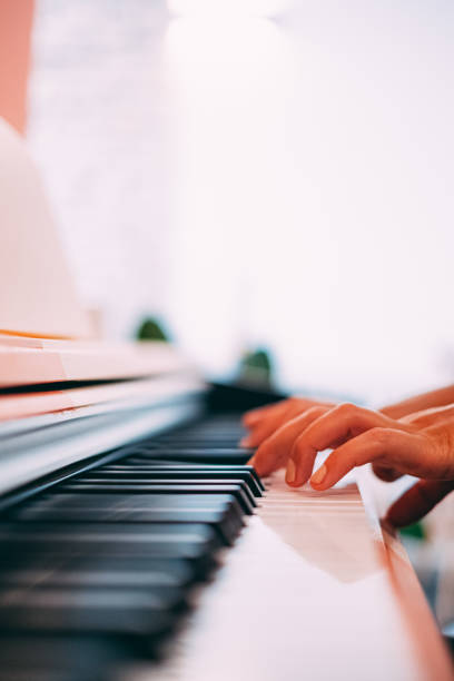 istock Woman Hands Playing the Piano 1176853764