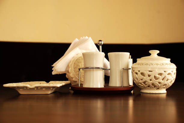 istock There is a set of white saltshaker and ashtray and tissue holder on a brown classy table great lightning no people 1176855014