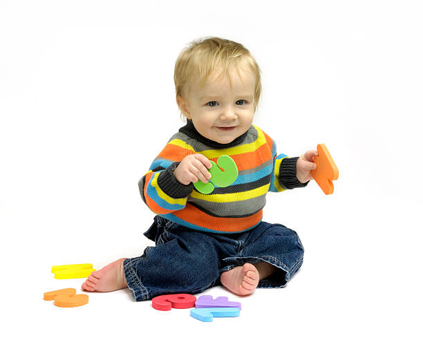 istock Baby boy playing with letters and numbers 117685583