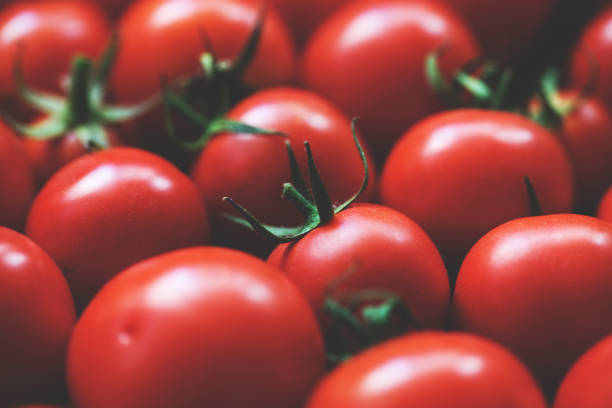 istock Cherry tomatoes on wooden table background 1176856222