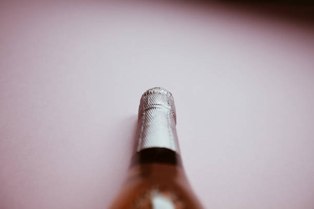 istock Bottle of rose champagne wine on pink background 1176857921