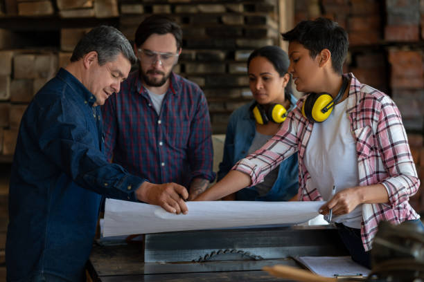 istock Architects talking to workers at a wood factory 1176857926