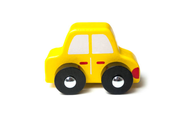istock yellow miniature wooden car on white background 1176858050