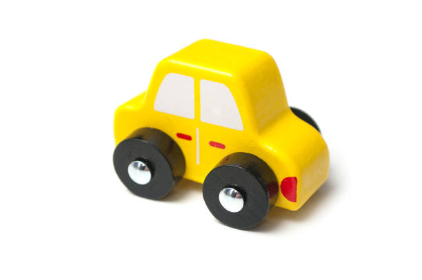 istock yellow miniature wooden car on white background 1176858051