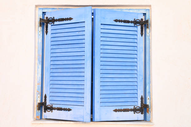 Turquoise wood window in old stone house