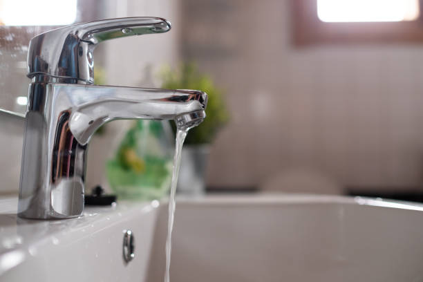 istock Open faucet washbasin with low water pressure 1176863027