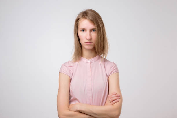 istock Dissatisfied young woman looking angrily at camera, showing irritated face expression 1176864592
