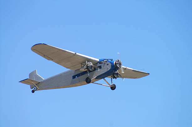 old passenger airplane Ford Trimotor flying in clear blue sky Old passenger airplane. Ford Trimotor. Built in 1929. 1920 1929 stock pictures, royalty-free photos & images