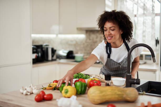 istock Mixed race woman reaching for pepper. 1176866073