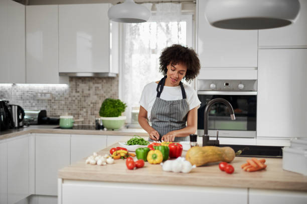 istock Mixed race housewife chopping mushrooms. 1176866365