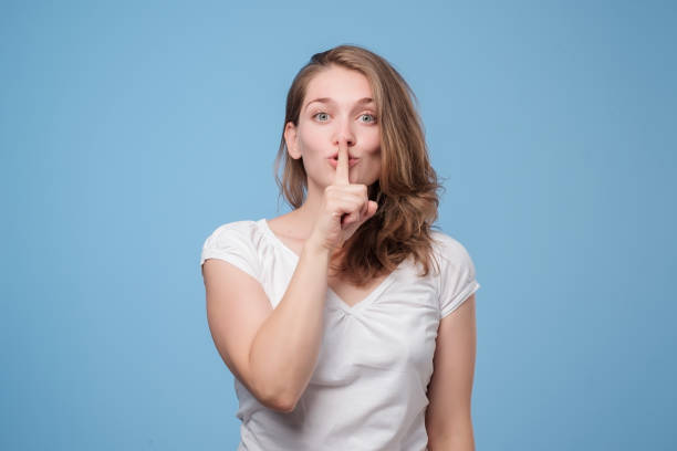 istock Serious lovely woman asks to keep secret information confidential. 1176868719