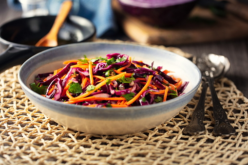 vegan spicy coleslaw made by freshness shredded red cabbage,carrot,red onion,green chilli with cumin olive oil dressing and chopped coriander