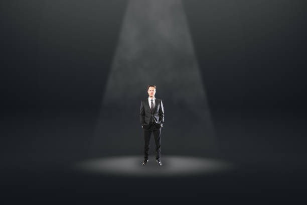 istock Businessman in black spotlight 1176877770
