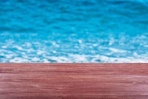 istock Empty wooden table top on shiny sea summer background 1176878835