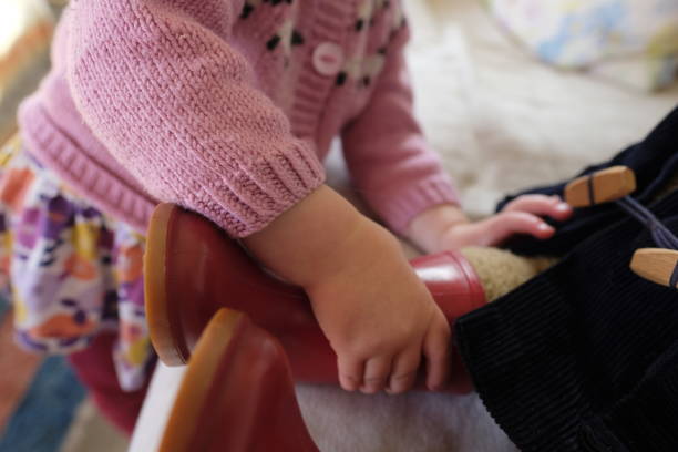 istock A young child pushing a red boot on to a toy teddy 1176878858