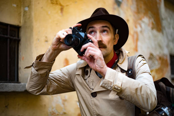 istock Detective taking pics in a sity slum with his vintage camera 1176885421