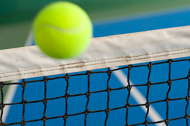 istock Rising tennis ball in action over the net 117688556