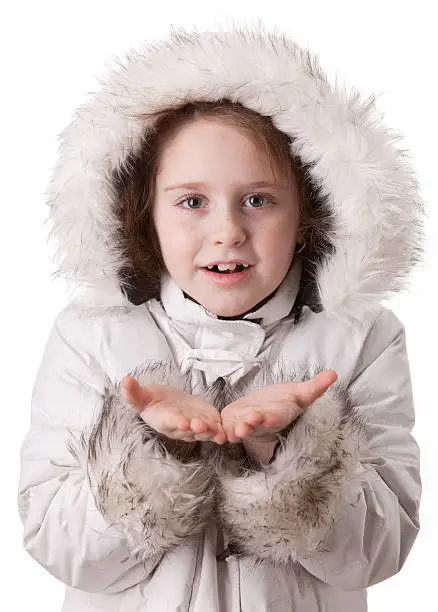 Little girl in the white coat show something on palms. For advetrizing and product placing
