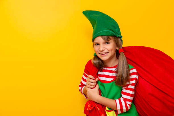 istock Christmas elf carrying sack of presents 1176894632
