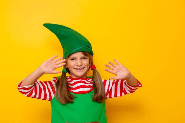 istock Child in elf costume waving 1176894787