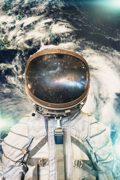 istock Cosmonaut or astronaut or spaceman in helmet at earth background view from outer space. Elements of this image furnished by NASA 1176894869