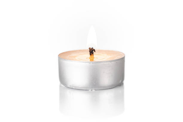 восковая чайная свеча изолирована на белом - tea light candle white single object стоковые фото и изображения