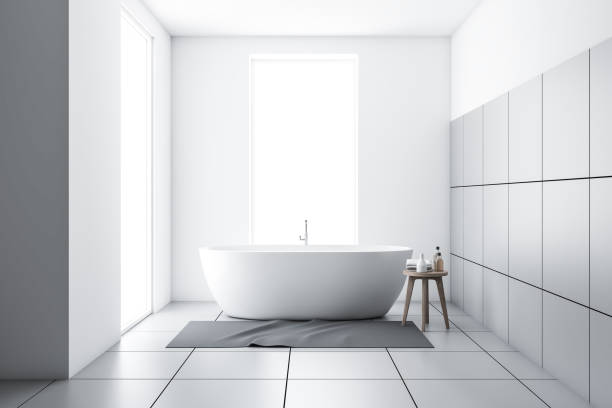 istock White tiled bathroom with tub and carpet 1176896426