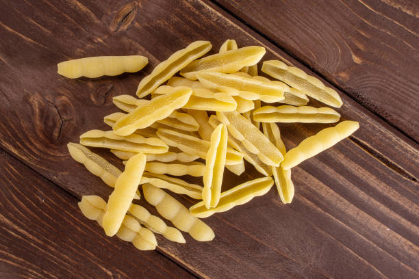 istock Raw cavatelli pasta on brown wood 1176898027