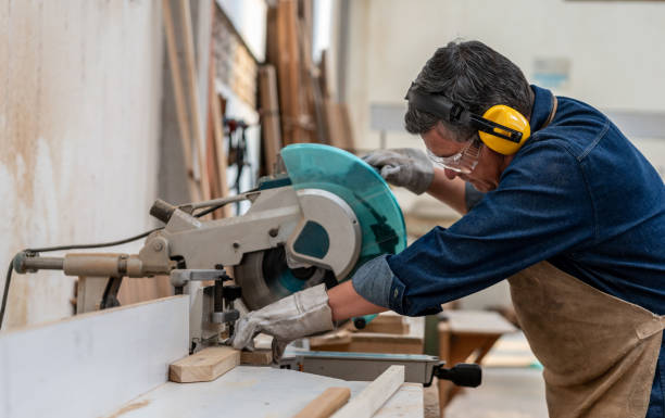 istock Man working at the carpentry cutting wood with a saw machine 1176899973