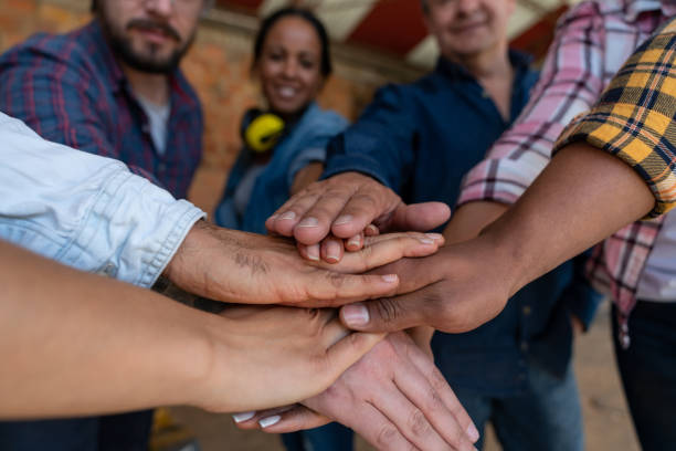 istock Close-up on a group of workers with their hands together 1176899992