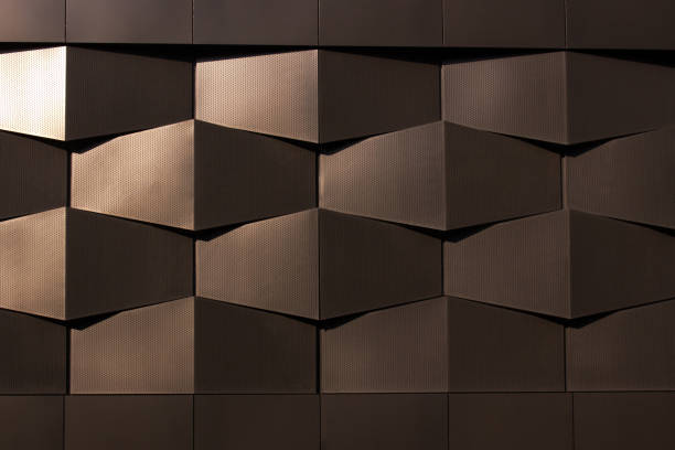 Wall of black metal structures in sun. Urban background
