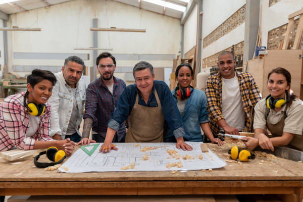 istock Group of people working at a carpentry 1176901104