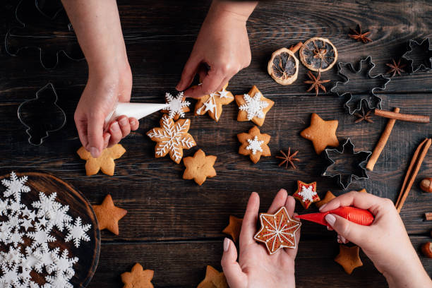 istock Friends decorating christmas gingerbread cookies 1176901787