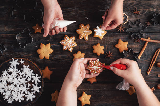 istock Friends decorating christmas gingerbread cookies 1176901792