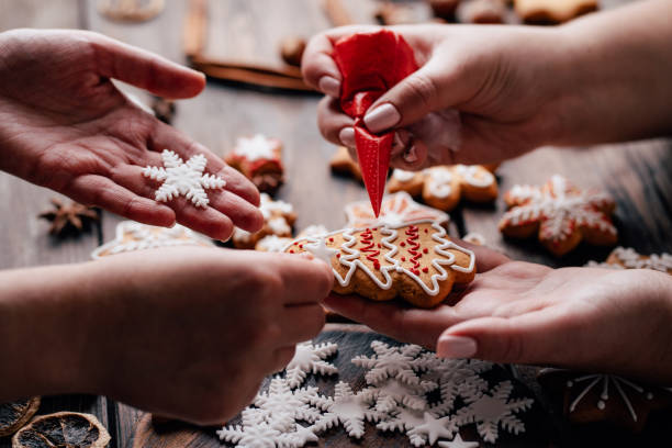 istock Friends decorating christmas gingerbread cookies 1176901799