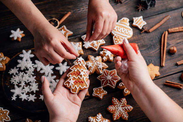 istock Friends decorating christmas gingerbread cookies 1176901808