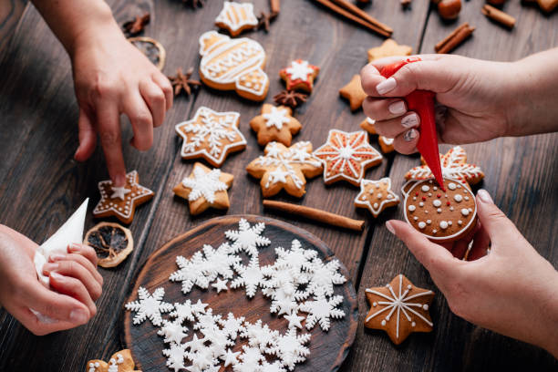 istock Friends decorating christmas gingerbread cookies 1176901812