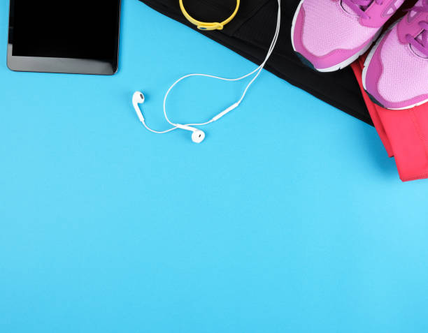 istock electronic tablet with empty black screen, next to it is fitness clothes 1176901974
