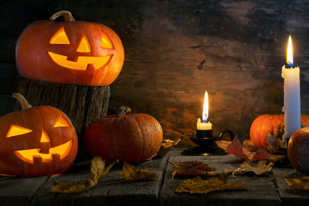 istock Halloween pumpkins head jack o lantern on wooden table background 1176903028