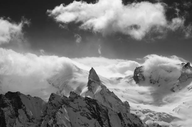 istock Black and white view on snowy high mountains peak 1176907005
