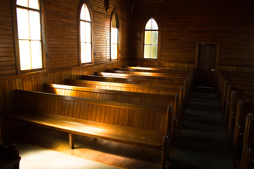 Light playing on an antique wooden church pew